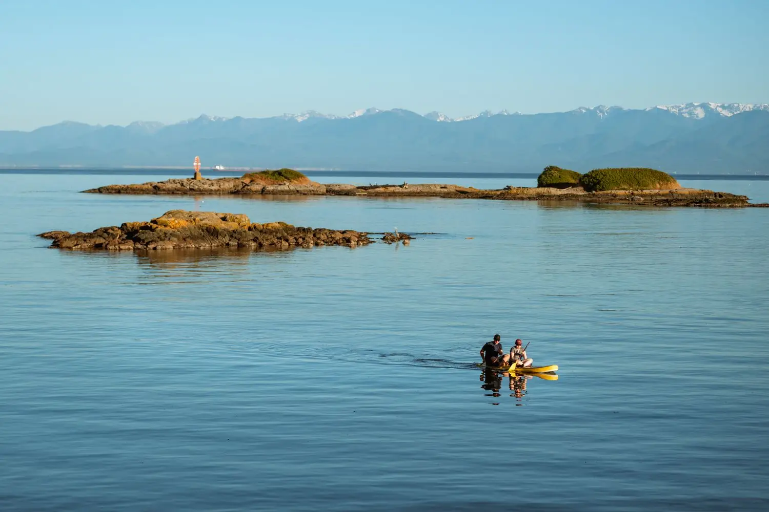 Calm coastal water with mountain horizon