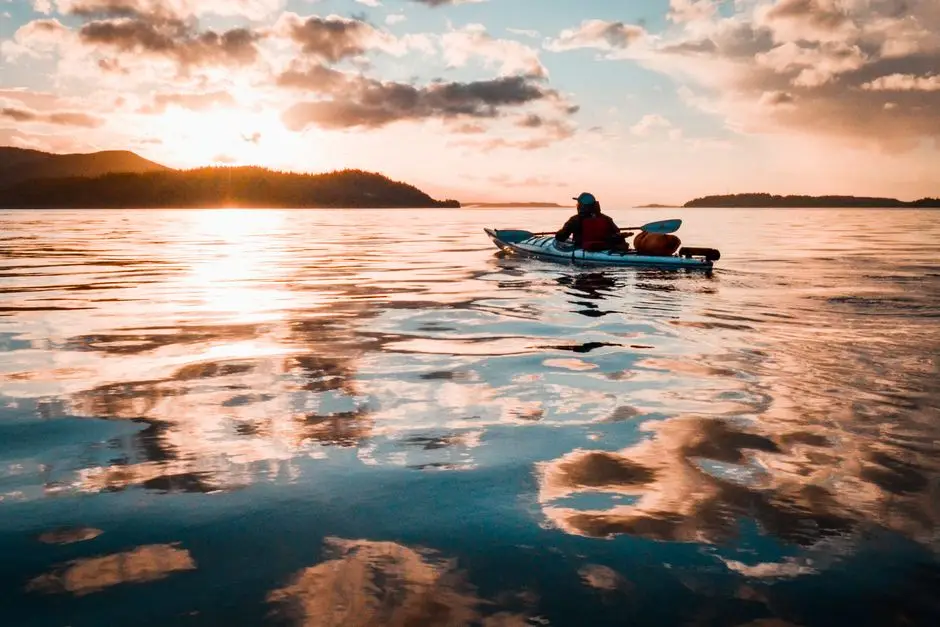 Kayakers moving across warm evening water