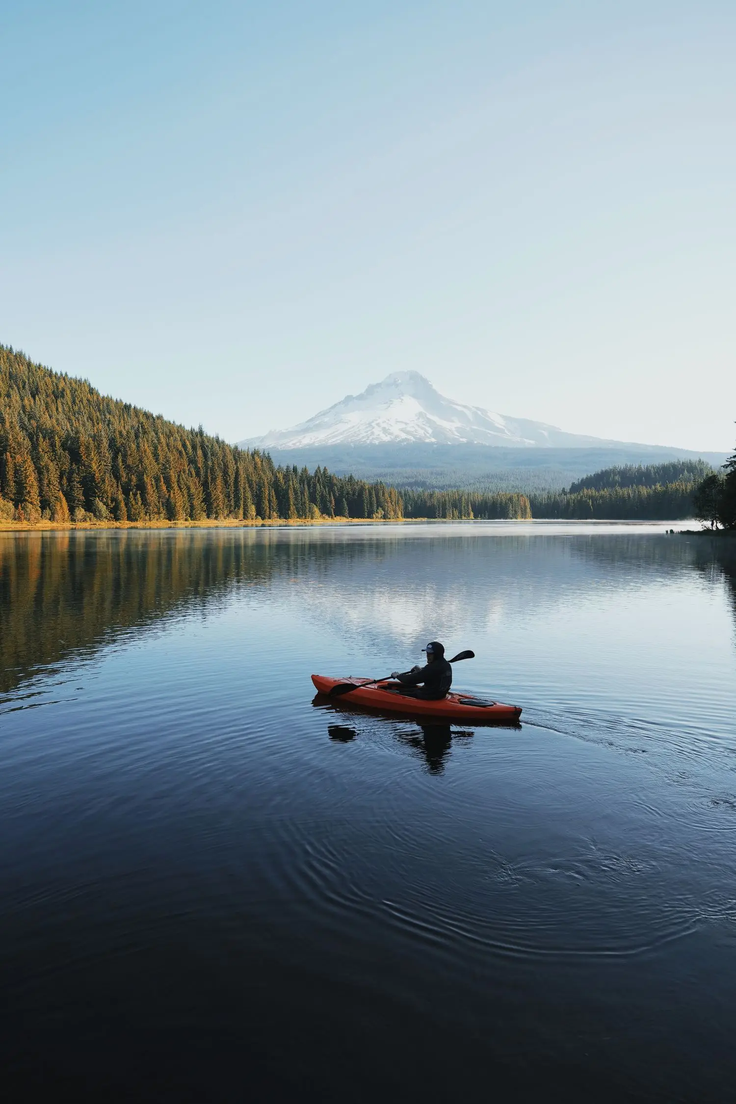 Solo kayaker on a calm lake